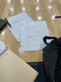 a backpack on a basketball court with papers on it